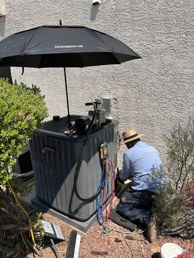 HVAC technician performing outdoor AC maintenance in Prunedale
